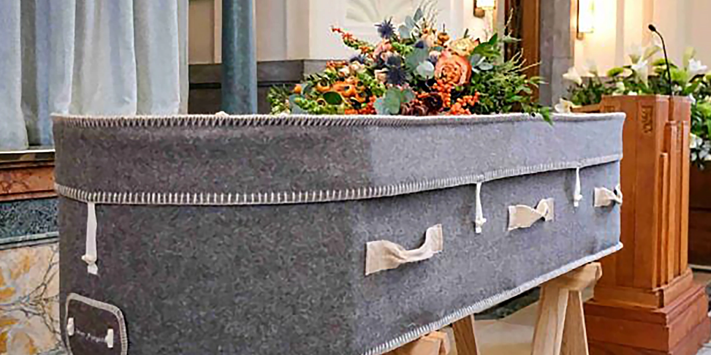 Coffin with floral arrangement in a cremation service