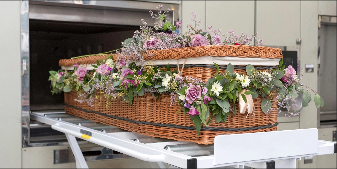 Wicker coffin with flowers for direct cremation.