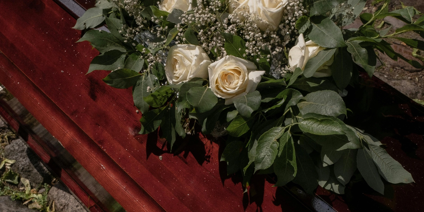 Floral arrangement on top of the coffin for viewing and cremation